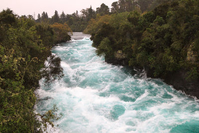 Scenic view of waterfall against sky