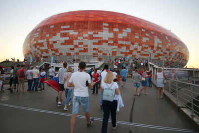 Group of people walking in front of buildings