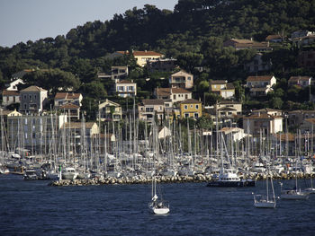 High angle view of townscape by sea against buildings