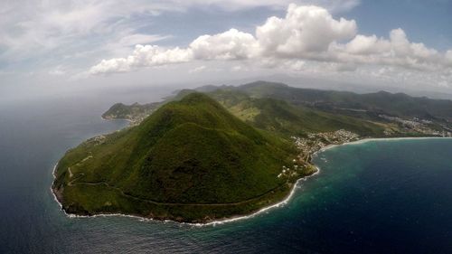 Scenic view of sea and mountains against sky