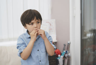 Portrait of boy looking at home