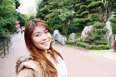 Portrait of young woman in park