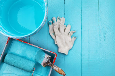 Directly above shot of paint and equipment on table