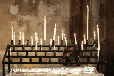 Close-up of illuminated candles in church