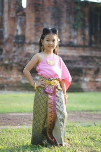 Portrait of a smiling girl standing outdoors