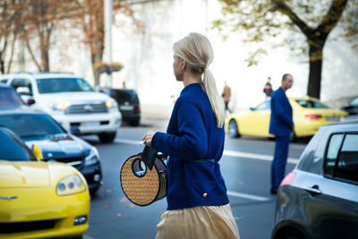 Rear view of woman standing on street