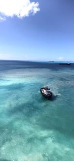 Sailboat in sea against blue sky