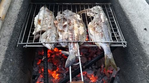 High angle view of meat on barbecue grill