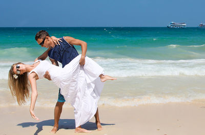 People dancing on sunny beach