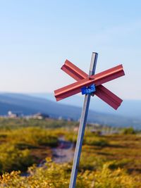 Close-up of wind turbines on field against clear sky