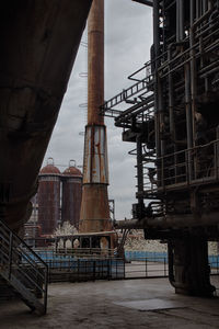 Low angle view of industrial building against sky