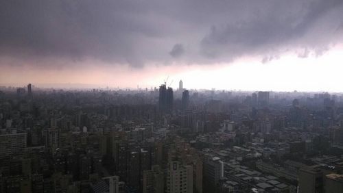 Cityscape against cloudy sky