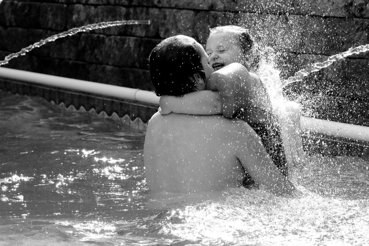 REAR VIEW OF PEOPLE WITH SWIMMING POOL