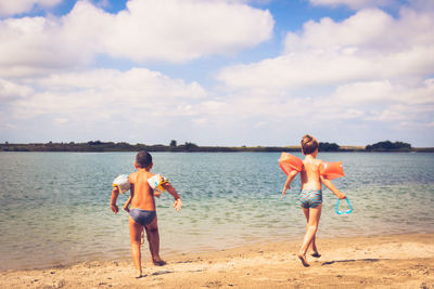 Carefree kids having fun and running on the beach. copy space.