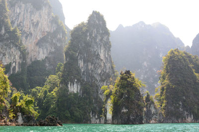 Scenic view of sea and mountains against sky