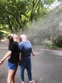 Rear view of couple walking on road