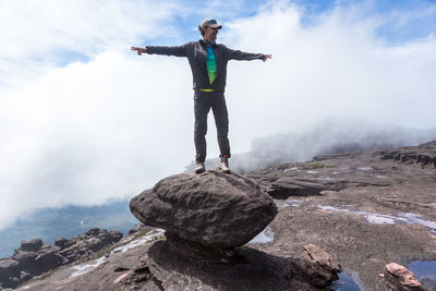 Full length of man on rock against sky