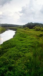 Scenic view of lake against cloudy sky