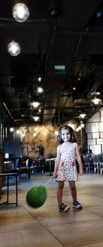 Full length of young woman standing in gym