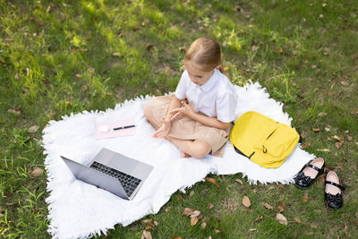 High angle view of woman sitting on field