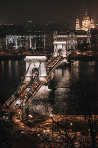 Aerial view of illuminated bridge in city at night