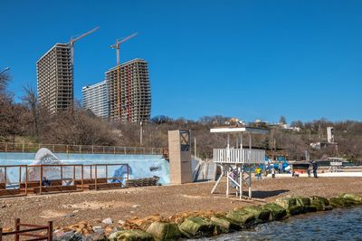 Buildings in city against clear blue sky