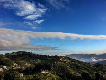 Scenic view of mountains against cloudy sky