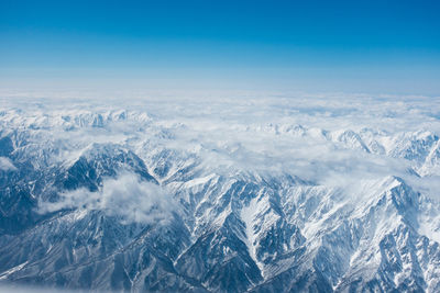 Aerial view of snowcapped mountains against sky