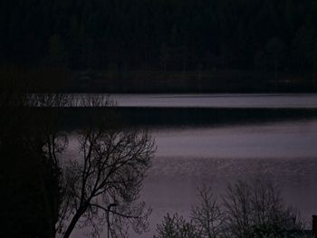 Scenic view of lake against sky at night