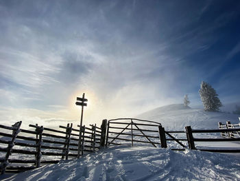 Snow covered field against sky