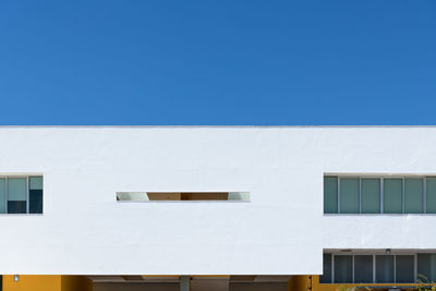 Low angle view of building against clear blue sky