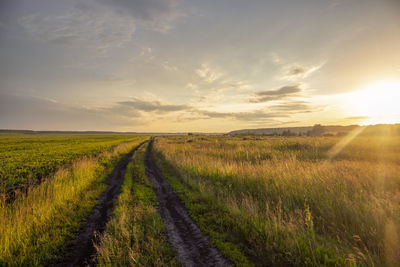 Scenic view of field against sky during sunset