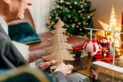 Midsection of man holding christmas tree