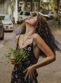 Woman lying down on street in city