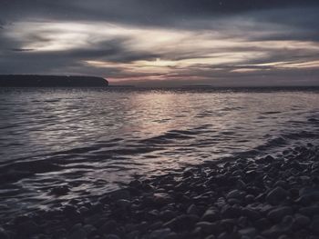 Scenic view of sea against cloudy sky