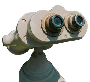 Close-up of coin-operated binoculars against white background