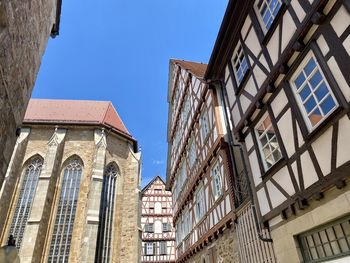 Low angle view of buildings against clear blue sky