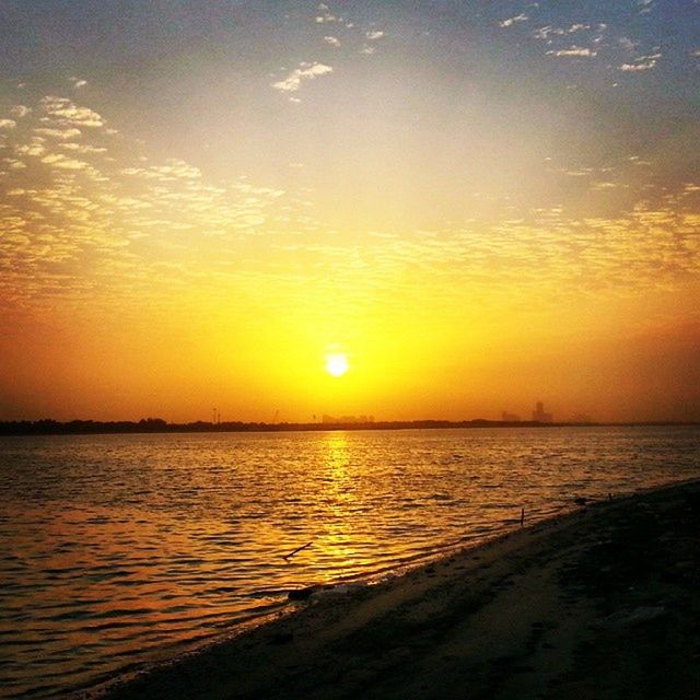 sunset, water, sea, sun, scenics, tranquil scene, orange color, beauty in nature, tranquility, sky, horizon over water, idyllic, nature, reflection, sunlight, rippled, beach, waterfront, silhouette, cloud - sky