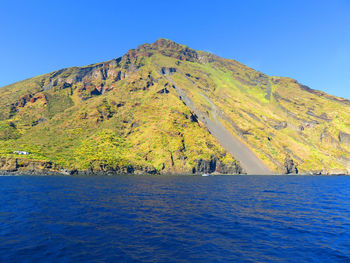 Scenic view of mountains against clear blue sky