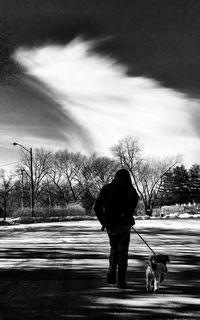 Rear view of people walking on road