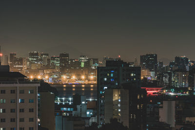 High angle view of illuminated buildings against clear sky at night