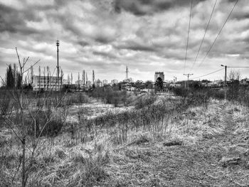 Scenic view of field against cloudy sky