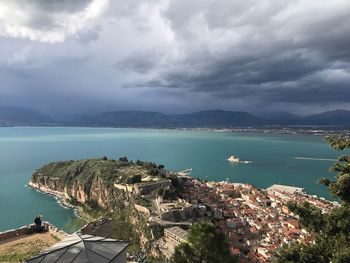 High angle view of sea and buildings against sky