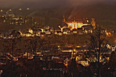 High angle view of illuminated buildings in city at night