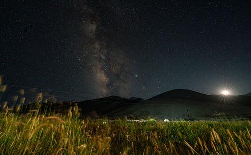 Scenic view of field against sky at night