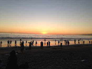 People on beach at sunset