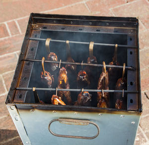 High angle view of meat on barbecue grill