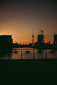 Silhouette of building against sky during sunset