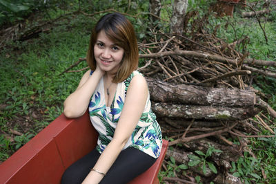 Portrait of young woman sitting outdoors