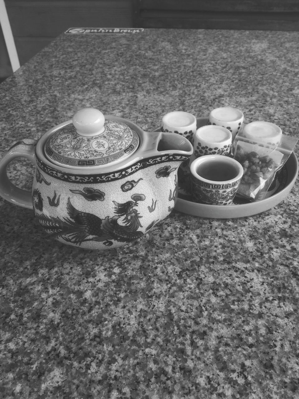 CLOSE-UP HIGH ANGLE VIEW OF CUP AND TABLE